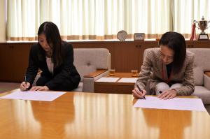 協定締結式の写真です。松下市長と株式会社レオパレス21の取締役がそれぞれ協定書にサインしています。